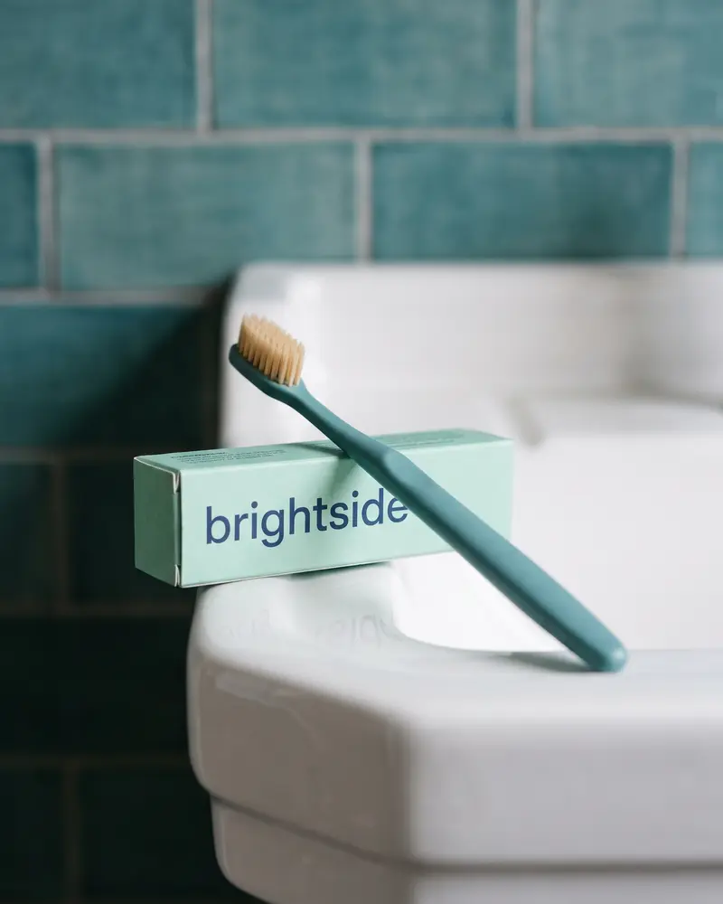 brightside toothpaste box and teal toothbrush